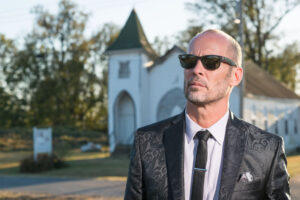 Photo of Paul Thorn standing in front of a church